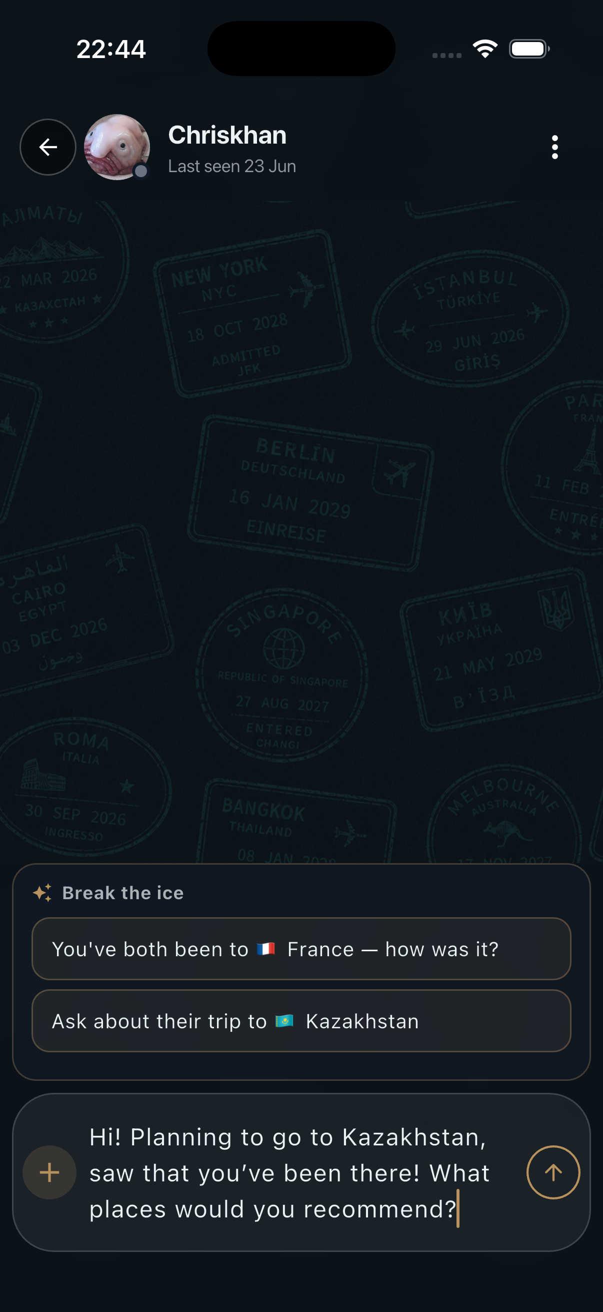 NomadMap chat on a passport-stamp background — ‘Break the ice’ suggestion chips reading ‘You've both been to France — how was it?’ and ‘Ask about their trip to Kazakhstan’, above a drafted message asking for Kazakhstan recommendations